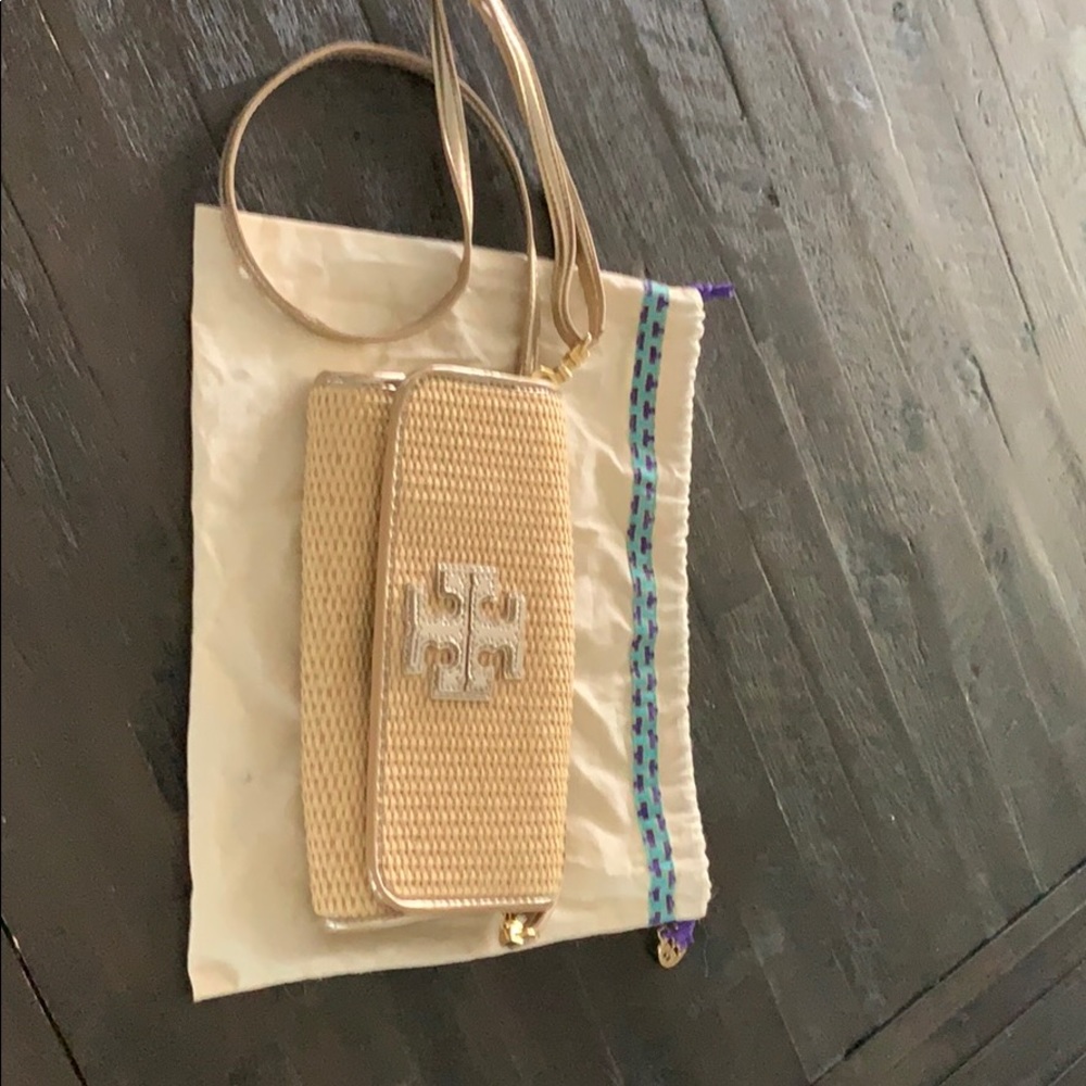 Straw clutch gold piping and removable strap.